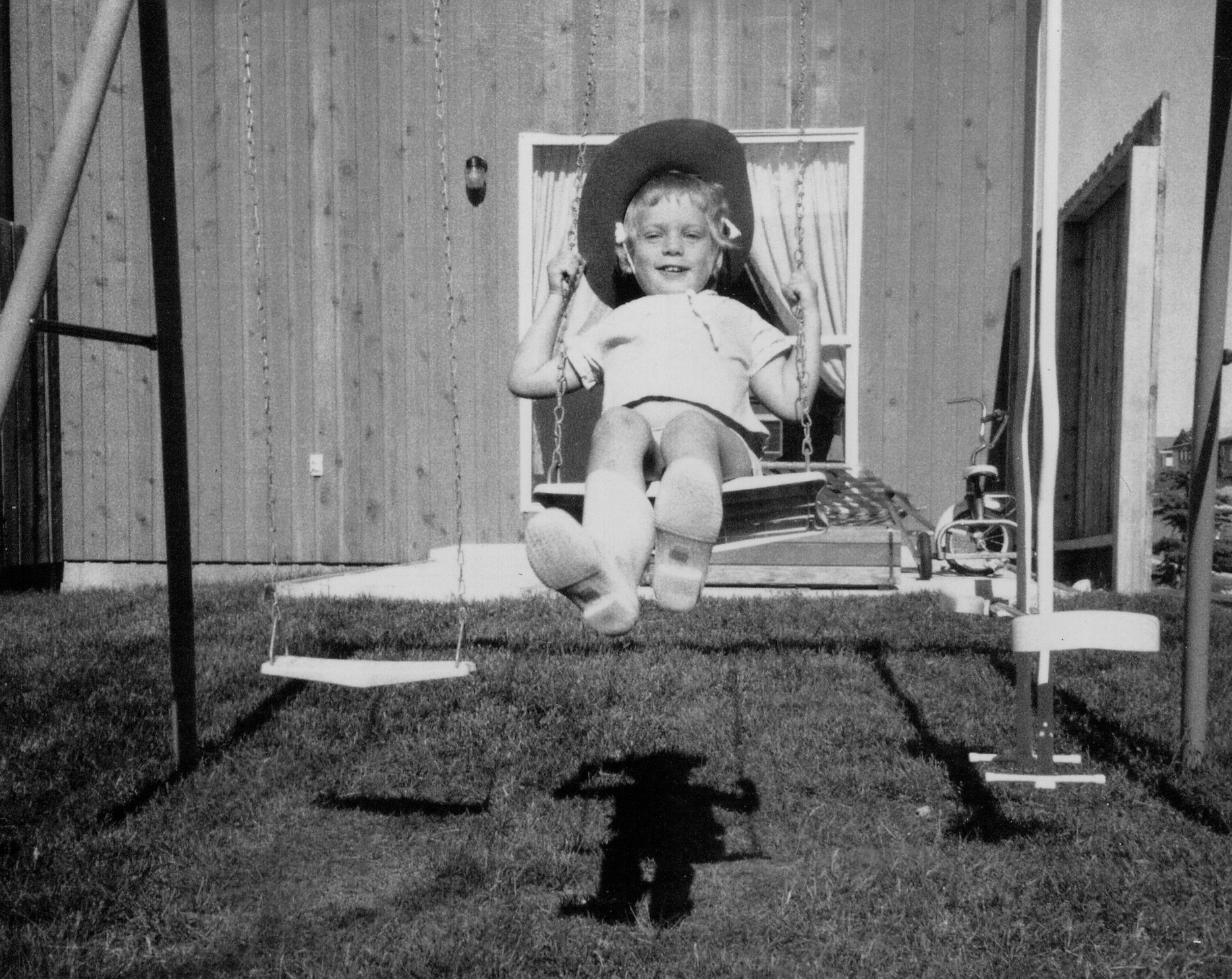 Christine, at 4 years old, on the swings